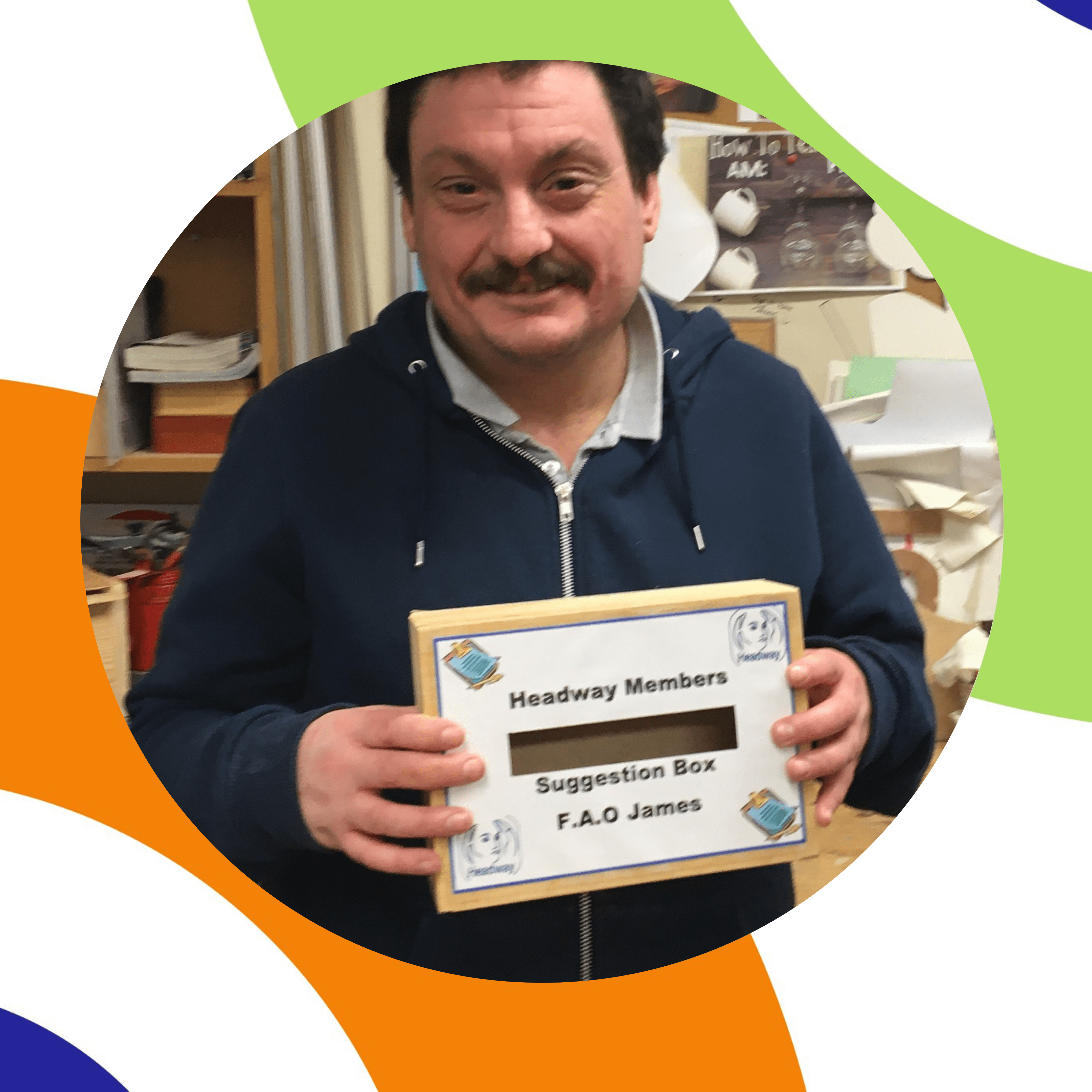 man holding suggestion box